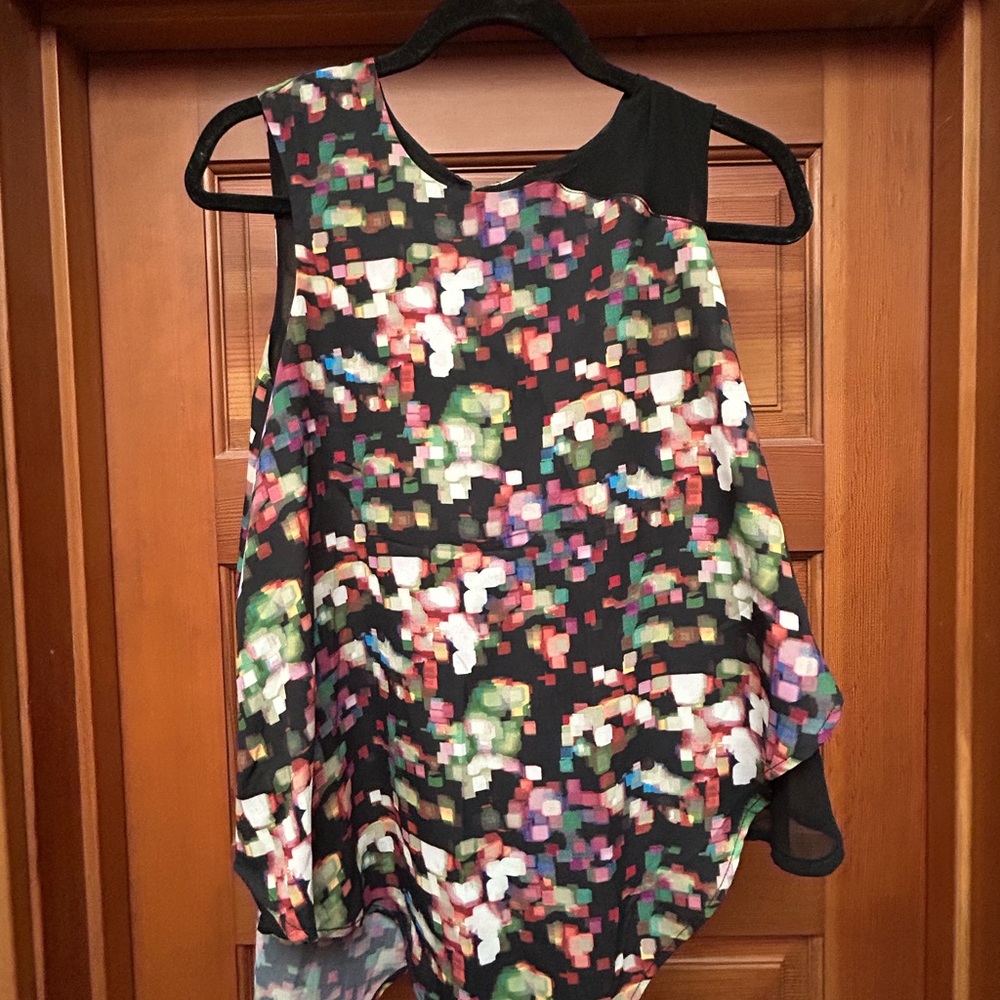 Multicolored asymmetrical sleeveless top, perfect for office to night out.